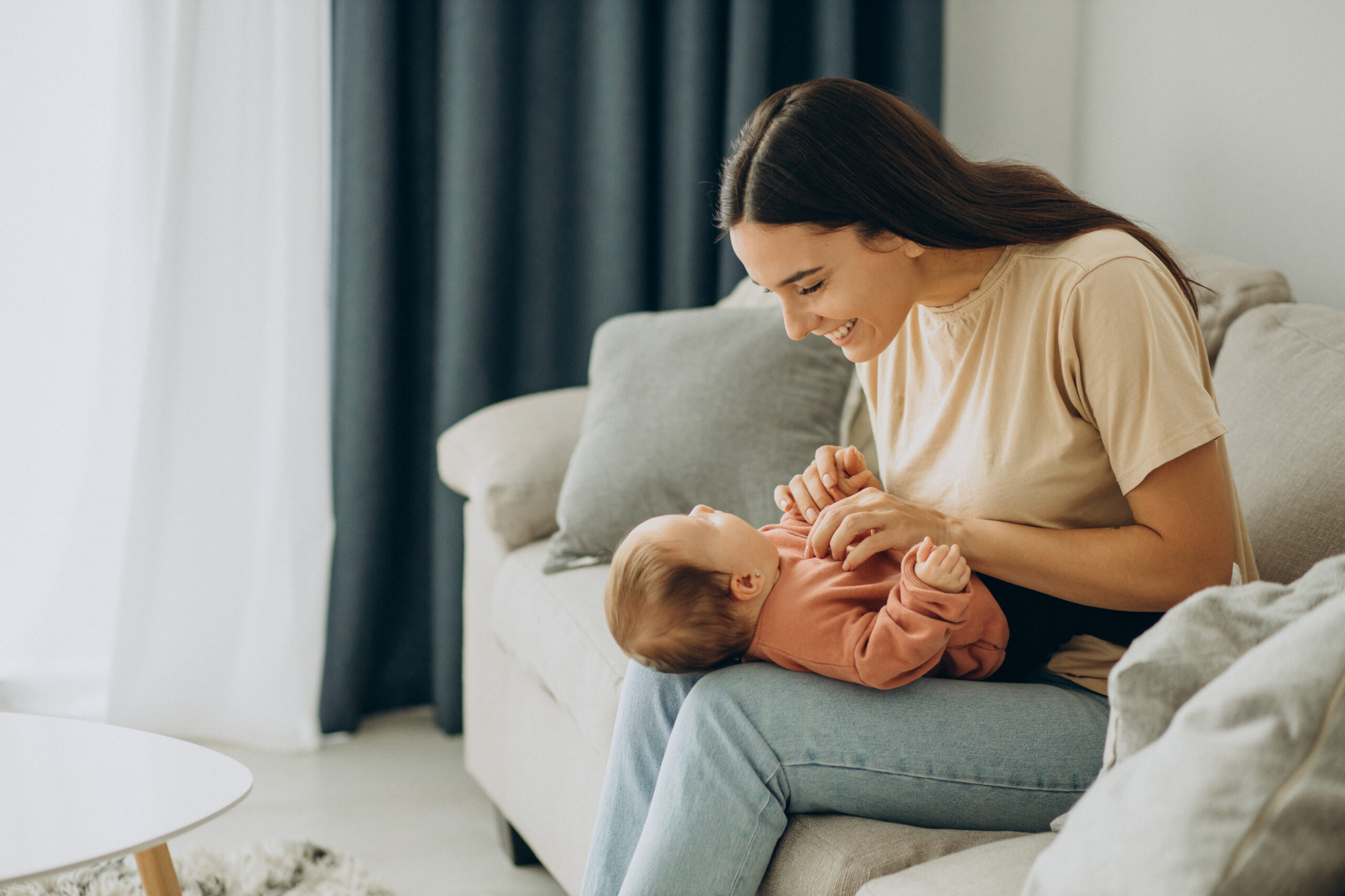 Mother with her baby girl at home